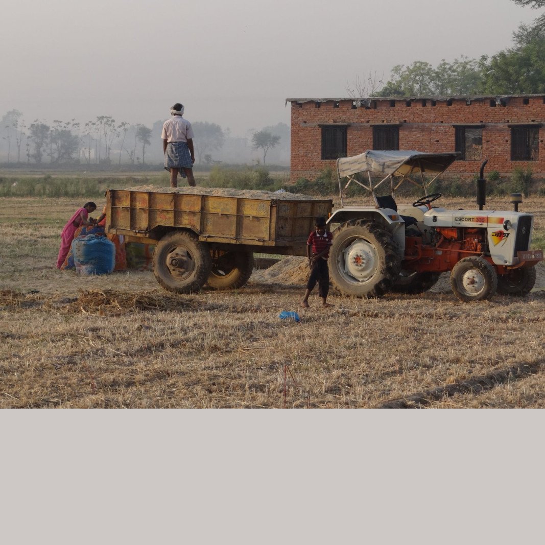 Farmers working with a tractor in an Indian field - agricultural machinery supplied by TMM Trades